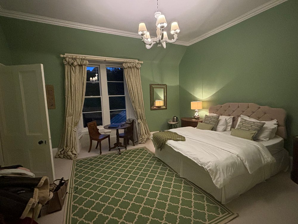 The Cedars room with green walls, super king bed and countryside views