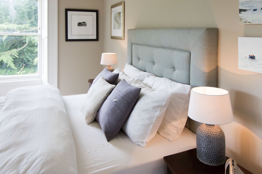 Lake View room with soft blues, king size bed and window overlooking the pond