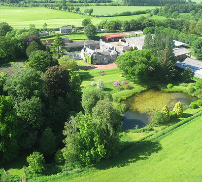 Aerial view of Newton Farmhouse with its wildlife pond and gardens