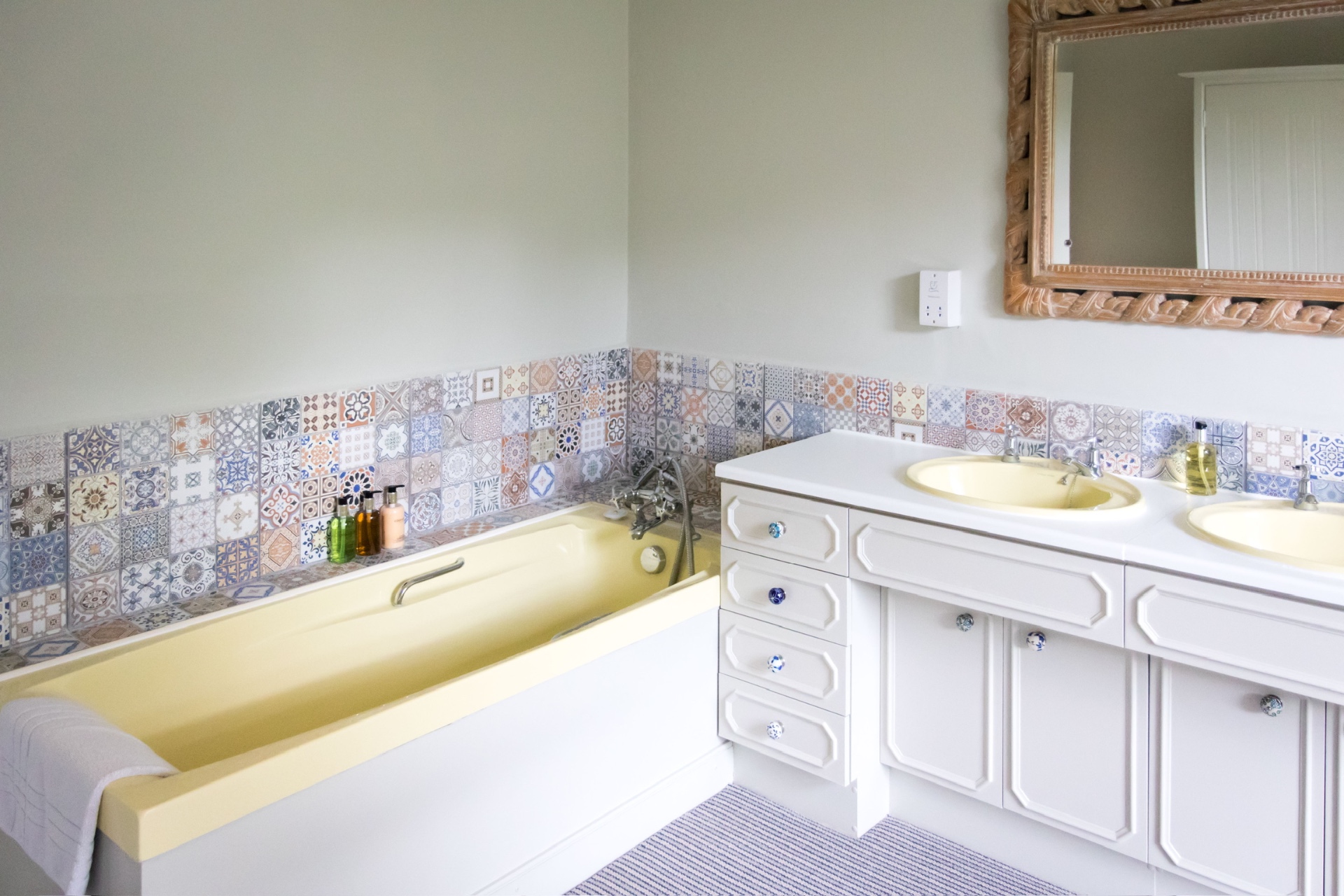 Bathroom with patterned mosaic tiles and twin basins
